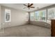 A well-lit bedroom with a ceiling fan and multiple windows offering natural light at 20784 W Minnezona Ave, Buckeye, AZ 85396