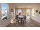 Bright dining area featuring travertine tile floors and abundant natural light from arched windows at 20784 W Minnezona Ave, Buckeye, AZ 85396