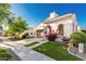 Attractive home featuring a tiled roof, two-car garage, and vibrant landscaping with curb appeal at 20784 W Minnezona Ave, Buckeye, AZ 85396