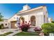 Attractive home with a tiled roof, two-car garage, and vibrant landscaping under a clear sky at 20784 W Minnezona Ave, Buckeye, AZ 85396