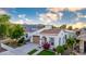 Beautiful home with desert landscaping, tile roof, well-maintained lawn, and a backdrop of mountains at 20784 W Minnezona Ave, Buckeye, AZ 85396