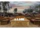 Inviting outdoor fire pit and seating area offering a relaxing space for gatherings with picturesque dusk views at 20784 W Minnezona Ave, Buckeye, AZ 85396