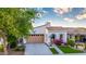 Charming home featuring an arched entryway, beautiful landscaping, and a two-car garage at 20784 W Minnezona Ave, Buckeye, AZ 85396
