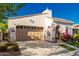 Beautiful home showcasing lush greenery, mature trees, and a two-car garage at 20784 W Minnezona Ave, Buckeye, AZ 85396