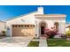 Inviting single-story home with a manicured lawn and a two-car garage at 20784 W Minnezona Ave, Buckeye, AZ 85396