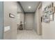 Inviting hallway with neutral tones, light tile flooring, and tastefully displayed Gathering photos at 20784 W Minnezona Ave, Buckeye, AZ 85396