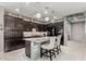 Modern kitchen with dark cabinetry, granite countertops, and a stylish central island at 20784 W Minnezona Ave, Buckeye, AZ 85396