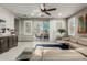 Comfortable living room with plush sofa, ceiling fan, and view of the outdoor patio at 20784 W Minnezona Ave, Buckeye, AZ 85396
