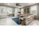 Spacious living room with tile floors, a ceiling fan, and patio access at 20784 W Minnezona Ave, Buckeye, AZ 85396