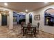 Covered patio with ornate dining set, tile flooring and recessed lights at 20784 W Minnezona Ave, Buckeye, AZ 85396