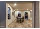 Covered patio with tile floors, arched doorways, and an ornate dining set at 20784 W Minnezona Ave, Buckeye, AZ 85396