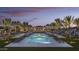Luxurious outdoor pool area surrounded by palm trees, lounge chairs, and elegant landscaping creating a serene retreat at 20784 W Minnezona Ave, Buckeye, AZ 85396