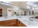 Bathroom with a large mirror, double sinks, wood cabinets, and lots of vanity space at 2527 E Villa Theresa Dr, Phoenix, AZ 85032