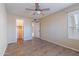 This bedroom features tile flooring, a ceiling fan, and a view to the closet at 2527 E Villa Theresa Dr, Phoenix, AZ 85032