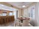 Charming dining area with modern lighting, wood cabinets, stainless steel appliances, and plantation shutters at 2527 E Villa Theresa Dr, Phoenix, AZ 85032