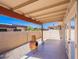 Covered patio area with an outdoor fireplace, providing a comfortable and stylish extension of the living space at 2527 E Villa Theresa Dr, Phoenix, AZ 85032