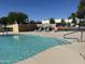 Relaxing community pool with lounge chairs, set against a backdrop of lush greenery and clear blue skies at 2527 E Villa Theresa Dr, Phoenix, AZ 85032