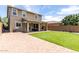 Spacious backyard with a manicured lawn, covered patio, and low-maintenance landscaping at 2562 N Springfield St, Buckeye, AZ 85396