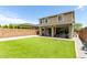 Large, well-manicured backyard with lush green lawn, covered patio, and privacy fence at 2562 N Springfield St, Buckeye, AZ 85396