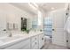 Bathroom features dual sinks, white cabinets, and neutral countertop at 2562 N Springfield St, Buckeye, AZ 85396