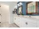 Bathroom featuring double sinks, custom framed mirrors, and ample counter space at 2562 N Springfield St, Buckeye, AZ 85396