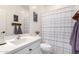 Bathroom featuring white cabinets and sink, toilet, and a shower with striped curtain at 2562 N Springfield St, Buckeye, AZ 85396