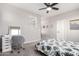 A bedroom featuring a ceiling fan, neutral colors, and a desk and chair setup at 2562 N Springfield St, Buckeye, AZ 85396