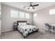 A bedroom featuring a ceiling fan, neutral colors, and ample natural light at 2562 N Springfield St, Buckeye, AZ 85396