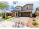Two-story home featuring a well-manicured lawn and a spacious two-car garage at 2562 N Springfield St, Buckeye, AZ 85396