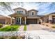 Two-story home with a manicured lawn and mature trees at 2562 N Springfield St, Buckeye, AZ 85396