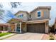 Two-story home featuring a well-manicured lawn and a spacious two-car garage at 2562 N Springfield St, Buckeye, AZ 85396