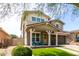 Two-story home with a charming front porch and manicured lawn at 2562 N Springfield St, Buckeye, AZ 85396