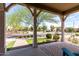 Covered front porch with a view of a landscaped street and basketball court at 2562 N Springfield St, Buckeye, AZ 85396