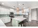 Bright kitchen featuring white cabinets, subway tile backsplash, stainless appliances, and an island at 2562 N Springfield St, Buckeye, AZ 85396