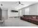 Spacious living room with gray walls, a large sectional sofa, and a ceiling fan at 2562 N Springfield St, Buckeye, AZ 85396