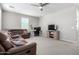 Comfortable living room featuring a large sofa, ceiling fan, and a dedicated workspace at 2562 N Springfield St, Buckeye, AZ 85396