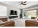 Comfortable living room featuring tile floors, large windows, and a view to patio at 2562 N Springfield St, Buckeye, AZ 85396