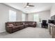 Living room featuring an L shaped couch and a ceiling fan at 2562 N Springfield St, Buckeye, AZ 85396
