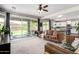 Cozy living room with tile floors, views to backyard, and an open floorplan leading to kitchen at 2562 N Springfield St, Buckeye, AZ 85396