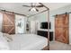 The primary bedroom features barn doors to the ensuite bathroom, adding rustic charm and privacy at 2562 N Springfield St, Buckeye, AZ 85396