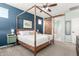 Primary bedroom features a four poster bed, ceiling fan, and a barn door that opens to the bathroom at 2562 N Springfield St, Buckeye, AZ 85396