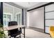 Bright office space featuring a desk and view of an outdoor living space through sliding glass doors at 2562 N Springfield St, Buckeye, AZ 85396
