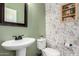 Powder room with floral wallpaper and pedestal sink at 2562 N Springfield St, Buckeye, AZ 85396