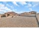 Expansive backyard featuring low-maintenance gravel landscaping and block perimeter fencing at 25787 W Allen St, Buckeye, AZ 85326