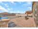 Spacious backyard with a brick patio area, gravel landscaping, and block fencing at 25787 W Allen St, Buckeye, AZ 85326