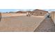Large gravel backyard featuring a patio, block wall, and low maintenance design at 25787 W Allen St, Buckeye, AZ 85326