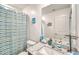 Bright bathroom with granite vanity and blue and green striped shower curtain at 25787 W Allen St, Buckeye, AZ 85326