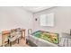 Bright bedroom featuring a twin bed, study desk, and a sunlit window at 25787 W Allen St, Buckeye, AZ 85326