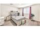 Bedroom features modern rustic headboard, window with purple curtains and neutral color palette at 25787 W Allen St, Buckeye, AZ 85326