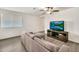Bright living room with sleek flooring, ceiling fan, and a cozy sectional sofa at 25787 W Allen St, Buckeye, AZ 85326